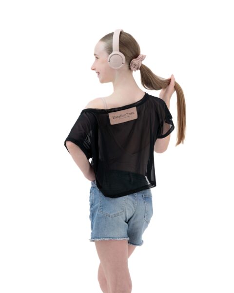 Girl with headphones wearing denim shorts with a leotard and crop top